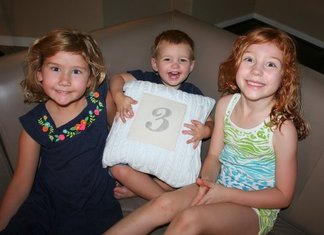 3 kids with number 3 pillow