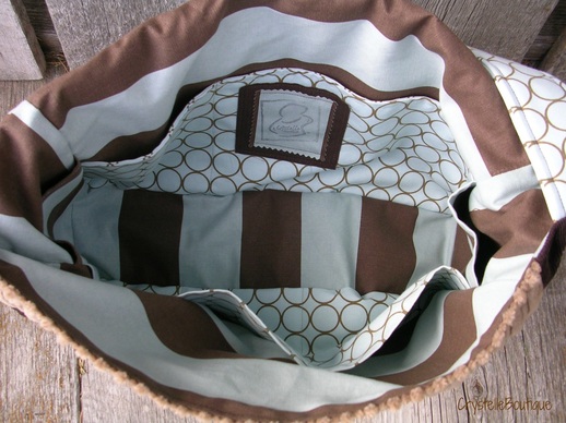 CrystelleBoutique - diaperbag - Lots of pockets and lots of room is the key to a great diaper-bag: pockets on the sides, a zippered pocket on the underside of the flap (!) and interior pockets: lots of them, all the way around.