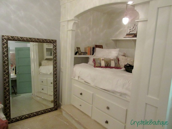 CrystelleBoutique - This lovely girl's room features a fabulous dream castle-like sleeping alcove, complete with steps, drawers, shelving, and (of course) a bed.